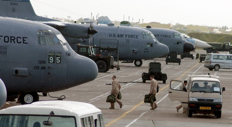 C-130 Hercules aircrew members board their aircraft for an Operation Enduring Freedom mission at Karshi-Khanabad Air Base, Uzbekistan, on April 19, 2005. C-130 Hercules aircrew members board their aircraft for an Operation Enduring Freedom mission at Karshi-Khanabad Air Base, Uzbekistan, on April 19, 2005.