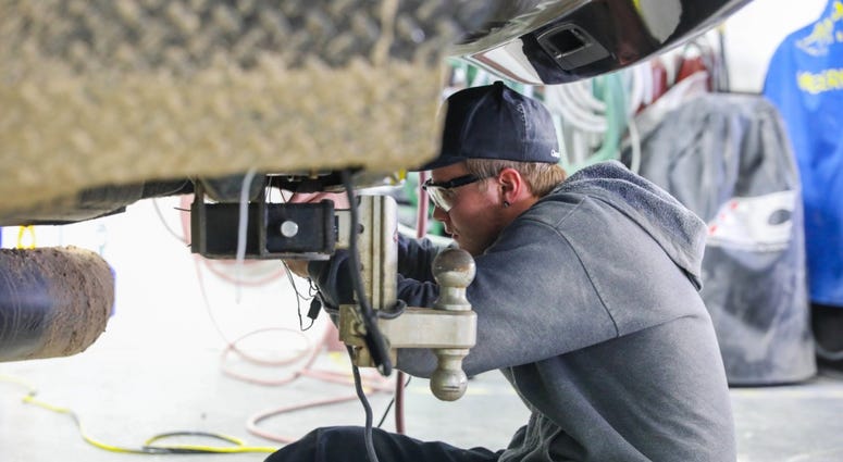Former U.S. Army Spc. Kalob Johannsen, a former infantryman assigned to 2nd Battalion, 12th Infantry Regiment, 2nd Infantry Brigade Combat Team, 4th Infantry Division, works on a vehicle, March 23, 2019, during Caliber Collision Academy. TransitionAssistanceProgramTAP