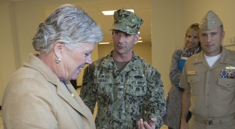 Capt. Mike Saum, commodore, Naval Construction Group (NCG) 1, presents a coin to Congresswoman Julia Brownley following a visit to the group’s Combat Convoy Simulator on Naval Base Ventura County (NBVC). JuliaBrownley