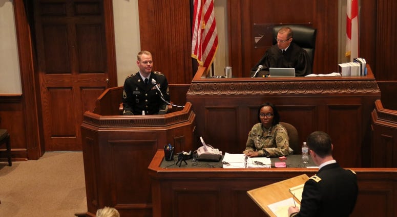 Trial Defense Council, questions the accused during the 4th annual 167th Theater Sustainment Command mock court martial.
