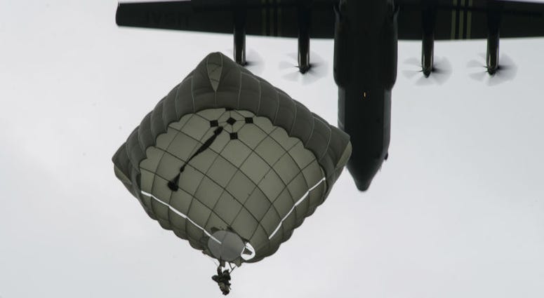 A static-line paratrooper prepares to land as a U.S. Air Force C-130J Super Hercules, assigned to the 37th Airlift Squadron, Ramstein Air Base. Over 1,000 U.S. paratroopers participate in largest airborne operation since WWII to commemorate 75th anniversary of D-Day.