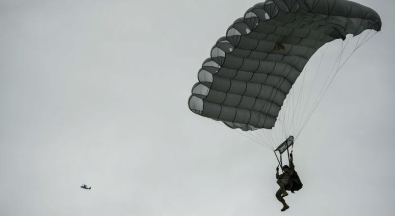 A military-free-fall paratrooper lands as a United States Air Force CV-22 Osprey. Over 1,000 U.S. paratroopers participate in largest airborne operation since WWII to commemorate 75th anniversary of D-Day.