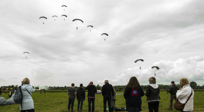 Military-free-fall parachutist prepare to land at Iron Mike Drop Zone outside of Saint-Mere-Eglise, France. Over 1,000 U.S. paratroopers participate in largest airborne operation since WWII to commemorate 75th anniversary of D-Day.