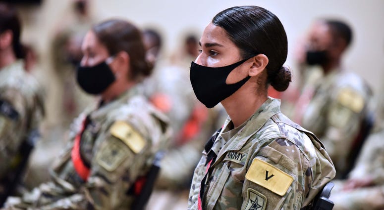 Advanced individual training soldiers wearing face masks listen to Maj. Gen. Dennis LeMaster