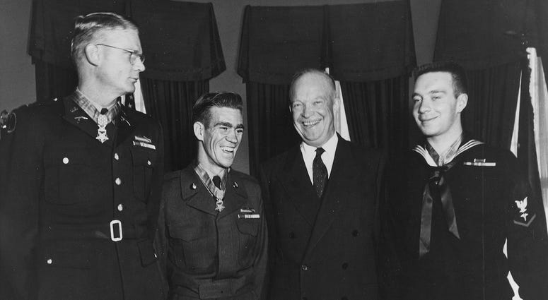 President Dwight D. Eisenhower poses with three men at White House in 1954 including Hospital Corpsman 3rd Class William Charette