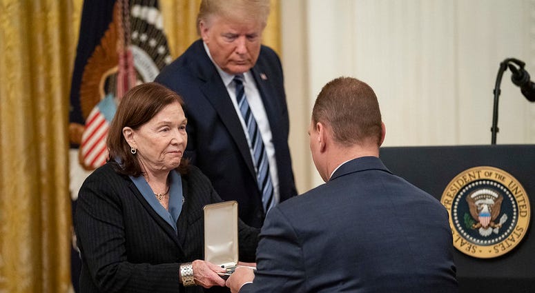 President Donald J. Trump looks on as Susan Rescorla shows the Presidential Citizens Medal, posthumously awarded to her husband Richard “Rick” C. Rescorla, to her son Trevor Thursday, Nov. 7, 2019.