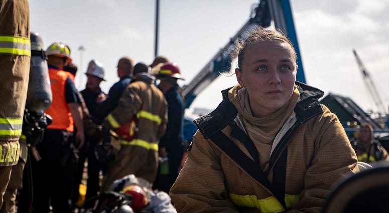 Navy firefighter rests