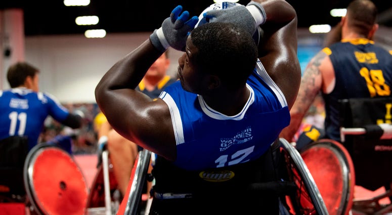 Air Force Senior Airman Demarcus Garrett leans back into a goal during the wheelchair rugby gold medal match Air Force Senior Airman Demarcus Garrett leans back into a goal during the wheelchair rugby gold medal match