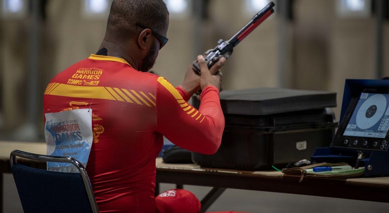 U.S. Marine Corps Veteran Staff Sgt. Anthony Reingoud, Team Marine Corps, reloads his weapon during the 2019 DoD Warrior Games shooting competition finals U.S. Marine Corps Veteran Staff Sgt. Anthony Reingoud, Team Marine Corps, reloads his weapon during the 2019 DoD Warrior Games shooting competition finals