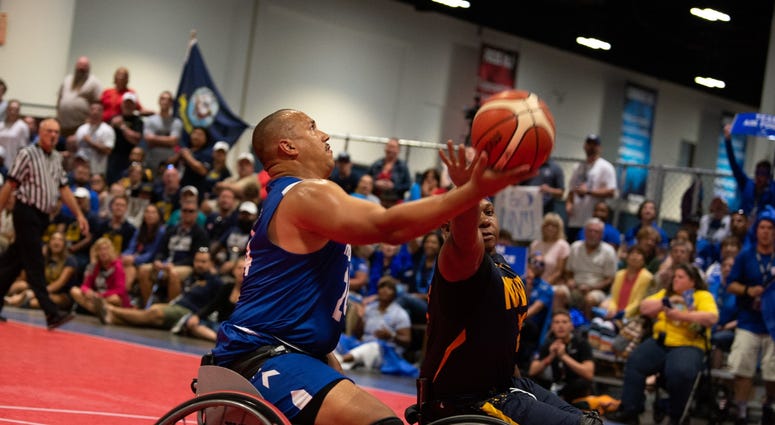 U.S. Air Force Senior Master Sgt. Brian Williams, Team Air Force, puts up a contested layup during the 2019 DoD Warrior Games wheelchair basketball gold medal game U.S. Air Force Senior Master Sgt. Brian Williams, Team Air Force, puts up a contested layup during the 2019 DoD Warrior Games wheelchair basketball gold medal game