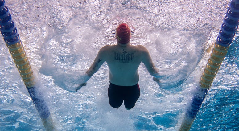 Marine Corps Veteran Pfc. Isaac Blunt competes in the 50 meter backstroke using his own unique swim technique Marine Corps Veteran Pfc. Isaac Blunt competes in the 50 meter backstroke using his own unique swim technique