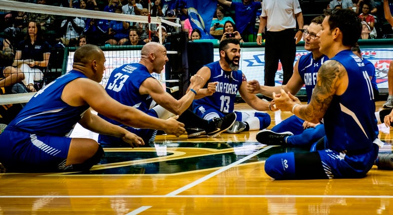 Team Air Force athletes celebrate after forcing a third game during the Department of Defense Warrior Games sitting volleyball finals Team Air Force athletes celebrate after forcing a third game during the Department of Defense Warrior Games sitting volleyball finals