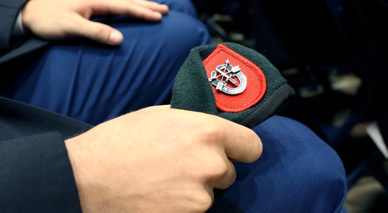 A Soldier from the U.S. Army John F. Kennedy Special Warfare Center and School, clutches his newly awarded green beret during a Regimental First Formation at the Crown Arena in Fayetteville, North Carolina August 1, 2019. The ceremony marked the completio A Soldier from the U.S. Army John F. Kennedy Special Warfare Center and School, clutches his newly awarded green beret during a Regimental First Formation at the Crown Arena in Fayetteville, North Carolina August 1, 2019. The ceremony marked the completio