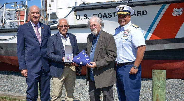 U.S. Representative Bill Keating, Bradley Finch, Stephen Finch, and Adm. Andy Tiongson pose for a photo
