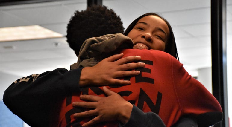Marva Burns smiles, as she hugs her son Marquis Butts