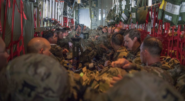 U.S. Army Soldiers, assigned to the East Africa Response Force (EARF), 101st Airborne Division, sit aboard a C-130J Super Hercules, assigned to the 75th Expeditionary Airlift Squadron, waiting to takeoff at Camp Lemonnier, Djibouti