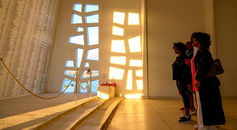 Family members of World War II hero Doris “Dorie” Miller stand at the end of the USS Arizona Memorial while on a boat tour of Joint Base Pearl Harbor-Hickam