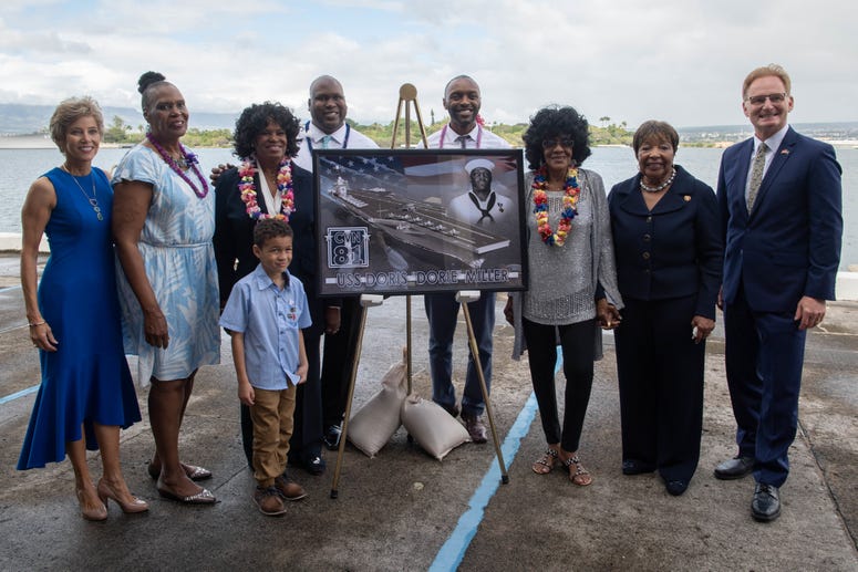 Acting Secretary of the Navy Thomas B. Modly, right, poses for a group photo with the Miller family after the unveiling of the new Ford-class aircraft carrier USS Doris Miller (CVN 81) Acting Secretary of the Navy Thomas B. Modly, right, poses for a group photo with the Miller family after the unveiling of the new Ford-class aircraft carrier USS Doris Miller (CVN 81)