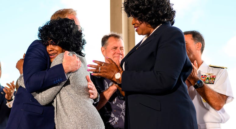 Brenda Haven, niece of World War II hero Doris “Dorie” Miller, hugs Acting Secretary of the Navy Thomas B. Modly after the unveiling of the new Ford-class aircraft carrier USS Doris Miller (CVN 81)