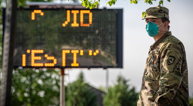A West Virginia National Guard Soldier waits for local citizens to arrive to be tested for COVID-19