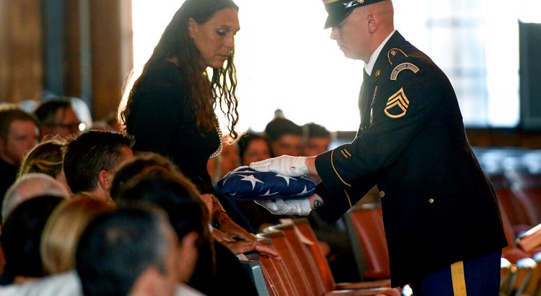 Natalie Henry-Howell, mother of Riley Howell, receives his flag from a military honor guard Student who charged a campus gunman remembered as a hero