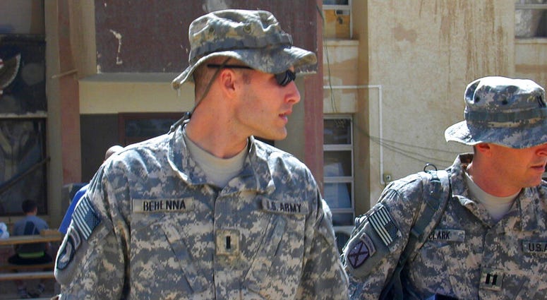In this Sunday, Sept. 21, 2008, file photo, 1st Lt. Michael C. Behenna, left, and his defense attorney Capt. Tom Clark, right, walk in Camp Speicher Trump pardons former US soldier who killed Iraqi prisoner