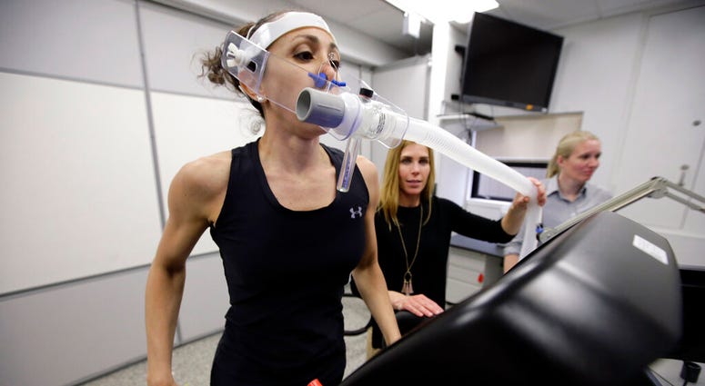 Research scientist Leila Walker, left, is assisted by nutritional physiologist Holly McClung, center, as they demonstrate equipment designed to evaluate fitness levels in female soldiers, who have joined elite fighting units such the Navy Seals. Research scientist Leila Walker, left, is assisted by nutritional physiologist Holly McClung, center, as they demonstrate equipment designed to evaluate fitness levels in female soldiers, who have joined elite fighting units such the Navy Seals.