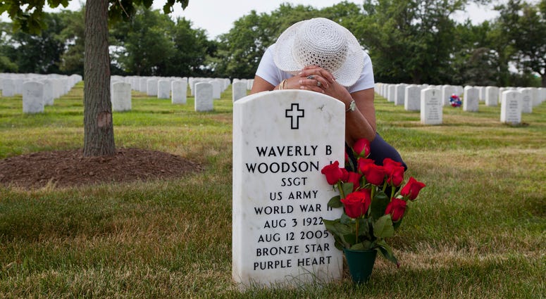 Joann Woodson at the grave site of Cpl. Waverly B. Woodson Jr. at Arlington National Cemetery in Arlington, Va. Joann Woodson at the grave site of Cpl. Waverly B. Woodson Jr. at Arlington National Cemetery in Arlington, Va.