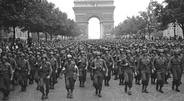 In this Aug. 29, 1944 file photo, U.S. soldiers of Pennsylvania's 28th Infantry Division march along the Champs Elysees