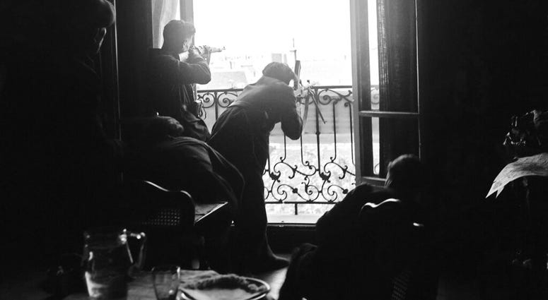 This Aug. 26, 1944 file photo shows members of the French Forces of the Interior (FFI) shoot at German snipers