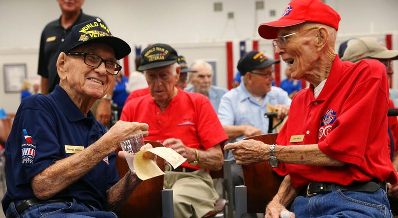 World War II veterans George Thomas, 97, left, and Clark Wilson, 93, enjoy conversation before a ceremony