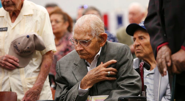 Cyrus Hayford Avey, Jr, 100, U.S. Air Force World War II veteran honors the flag during a ceremony at Joint Base San Antonio-Fort Sam Houston