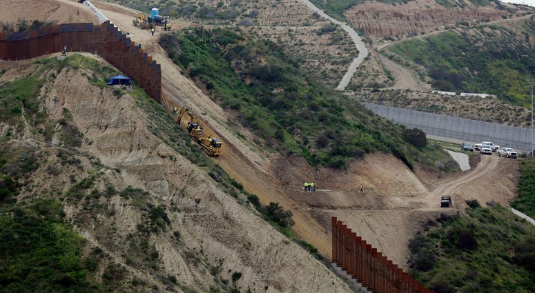 n this March 11, 2019 photo, construction crews replace a section of the primary wall separating San Diego, above right, and Tijuana, Mexico, below left, seen from Tijuana, Mexico.