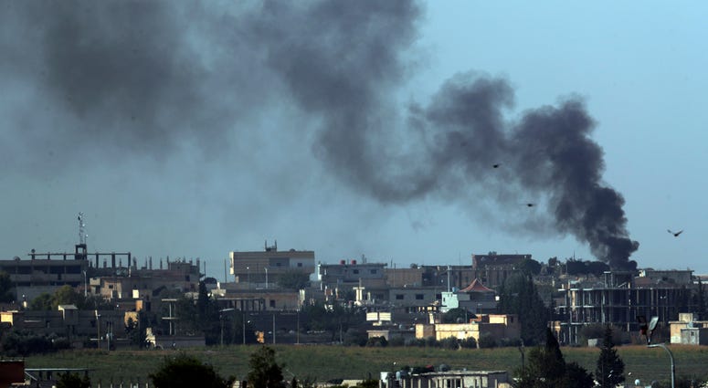 In this photo taken from the Turkish side of the border between Turkey and Syria, in Akcakale, Sanliurfa province, southeastern Turkey, smoke billows from targets in Tel Abyad, Syria, during bombardment by Turkish forces, Friday, Oct. 11, 2019. SyriaTurkey