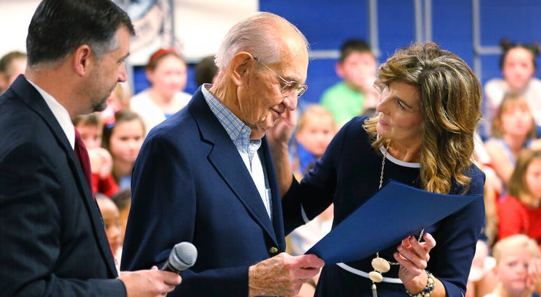 WWII veteran James Wallace Yarbrough, center, is presented an honorary diploma