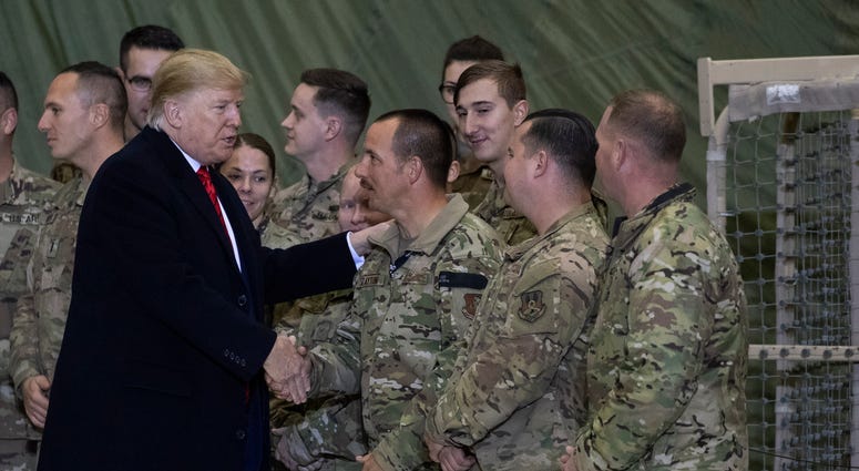 President Donald Trump greeting members of the military after speaking to members of the military during a surprise Thanksgiving Day visit. President Donald Trump greeting members of the military after speaking to members of the military during a surprise Thanksgiving Day visit.