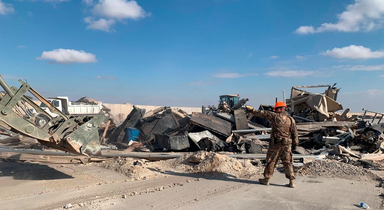U.S. soldiers clear rubble from a site of Iranian bombing at Ain al-Asad air base in Anbar, Iraq
