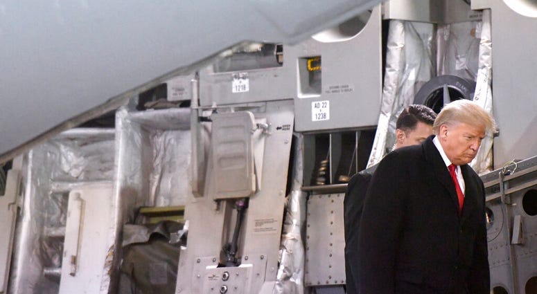 President Donald Trump disembarks a C-17 aircraft after a prayer for Sgt. 1st Class Javier Jaguar Gutierrez and Sgt. 1st Class Antonio Rey Rodriguez