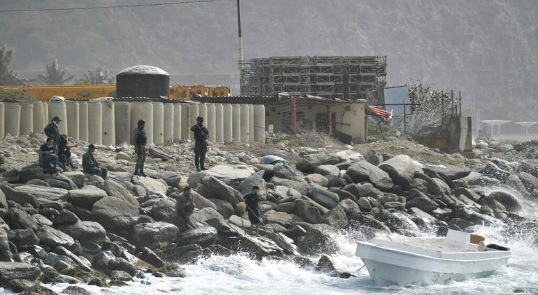 Security forces guard the shore area
