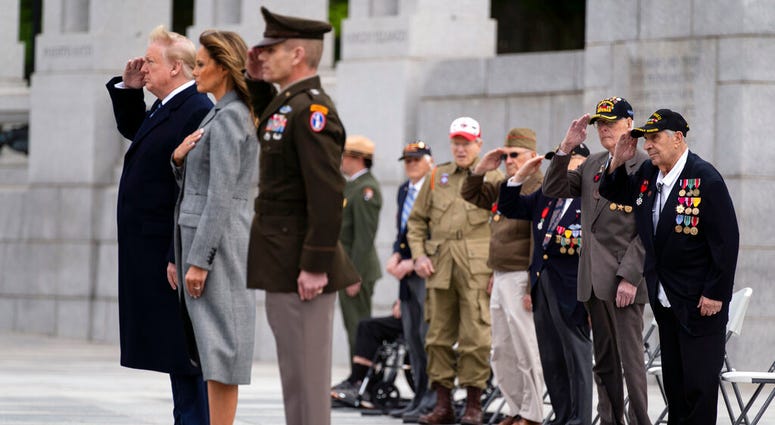 World War II veterans salute as Taps is played during a ceremony at the World War II Memorial to commemorate the 75th anniversary of Victory in Europe Day with President Donald Trump and first lady Melania Trump, Friday, May 8, 2020, in Washington. VEDay2020