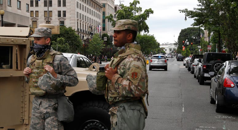 Members of the DC National Guard block an intersection on 16th Street as demonstrators gather to protest the death of George Floyd