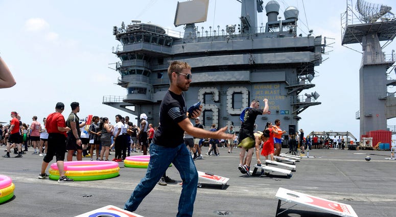 Sailors participate in sporting events on the flight deck of the aircraft carrier USS Dwight D. Eisenhower