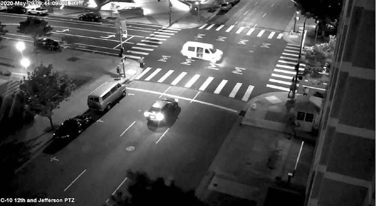 A van's passenger side door is open as someone fires at a security kiosk
