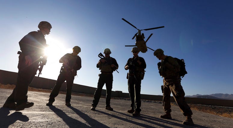 American soldiers wait on the tarmac in Logar province, Afghanistan, 2017