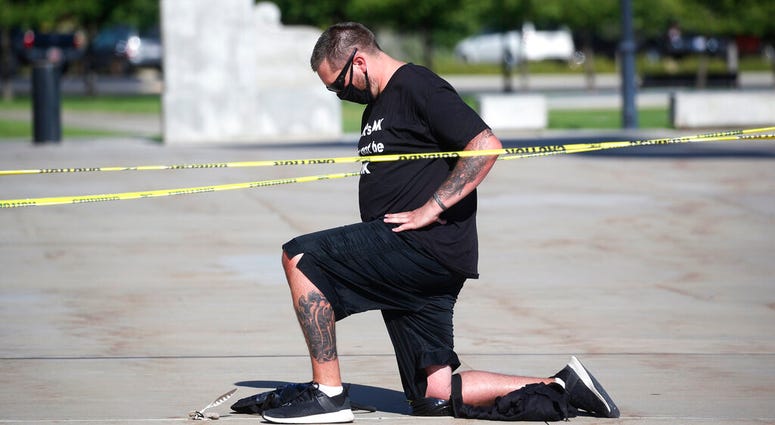 Shane Brooks, a Marine Corps veteran, kneels for nine hours outside the Utah Capitol to call attention to racial injustice