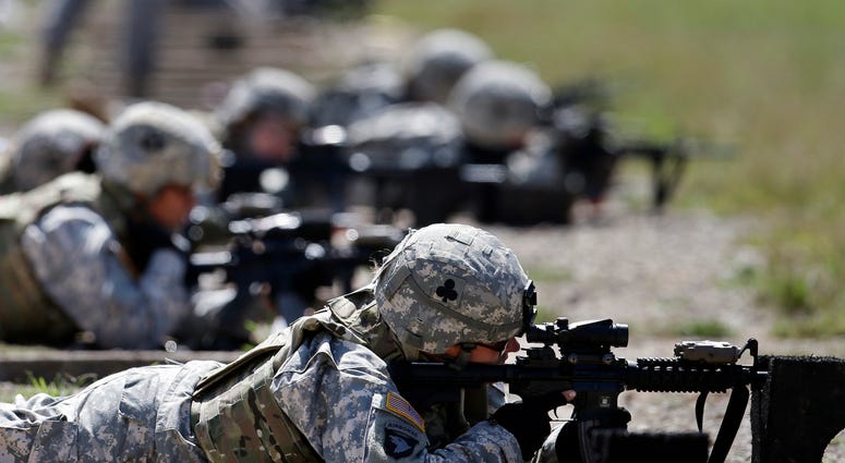 In this Sept. 18, 2012 file photo, female soldiers from 1st Brigade Combat Team, 101st Airborne Division train on a firing range while testing new body armor in Fort Campbell, Ky. In this Sept. 18, 2012 file photo, female soldiers from 1st Brigade Combat Team, 101st Airborne Division train on a firing range while testing new body armor in Fort Campbell, Ky.