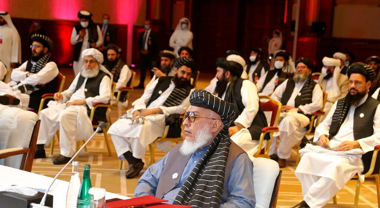 In this Sept. 12, 2020, file photo, Taliban negotiator Abbas Stanikzai, center front, and his delegation attend the opening session of peace talks between the Afghan government and the Taliban