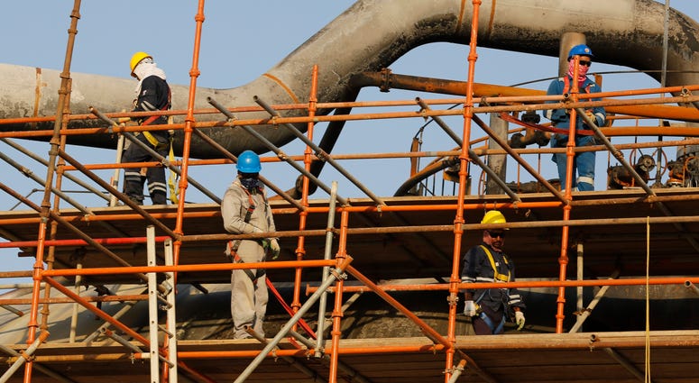 During a trip organized by Saudi information ministry, workers fix the damage in Aramco's oil separator at processing facility after the recent Sept. 14 attack in Abqaiq, near Dammam in the Kingdom's Eastern Province, Friday, Sept. 20, 2019. Saudi Arabia The Latest: US to deploy more troops to Saudi Arabia, UAE