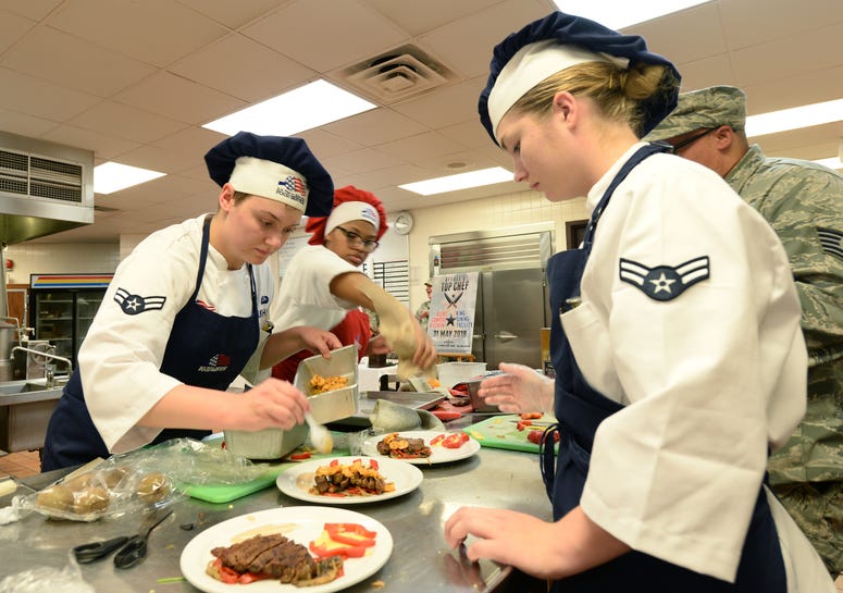 Teammates Airman 1st Class Aubry Burkhardt, Airman 1st Class Madison Farley and Airman Aminah Griffin, 55th Force Support Squadron Sustainment Flight food service apprentices, compete in a top chef competition May 31, 2018 at Offutt Air Force Base, Nebras