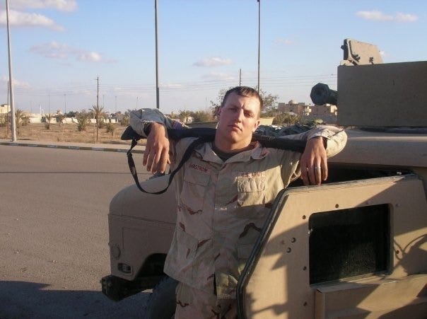 Jan Ohstrom poses in Iraq with his weapon over his shoulders.